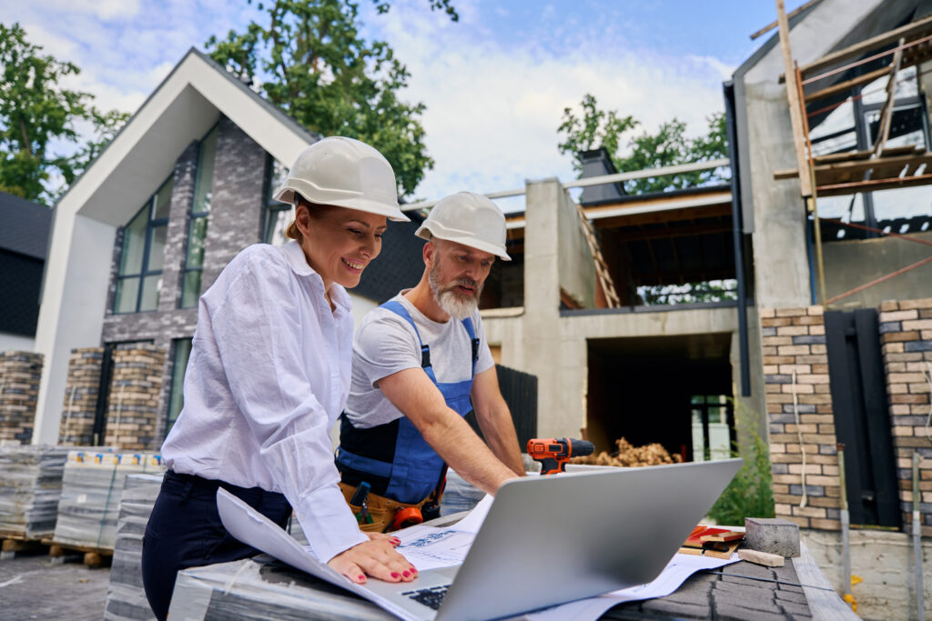 Custom home builders in Navarre discussing architectural plans on-site