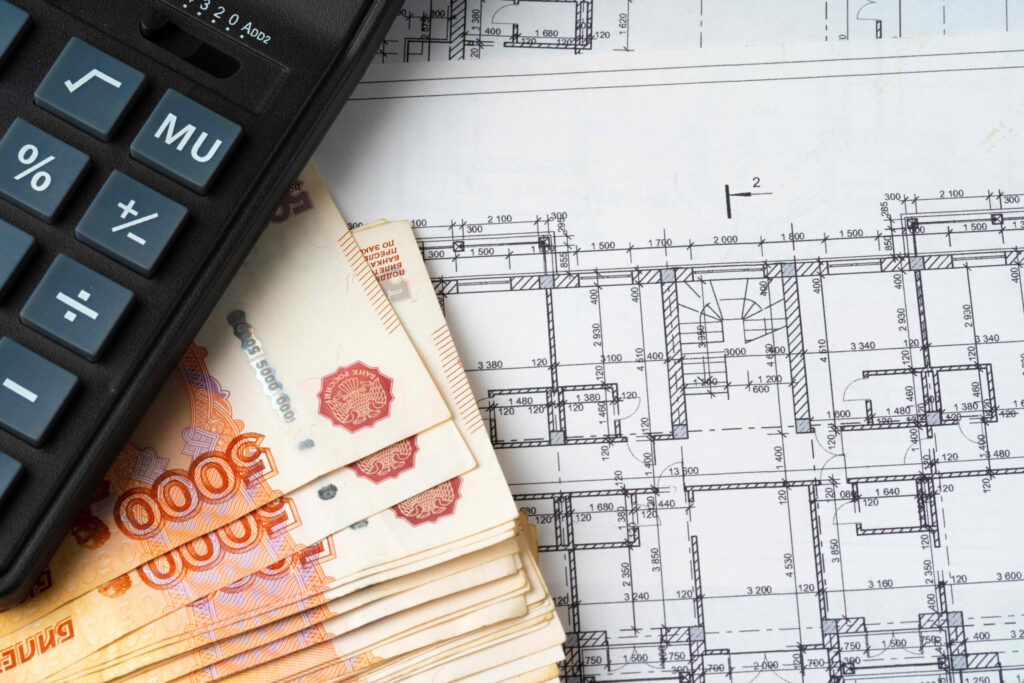 Russian roubles stack on blueprints wth calculator Renovation building expenses concept - EZ Modern Homes Russian roubles stack on blueprints wth calculator Renovation building expenses concept - EZ Modern Homes